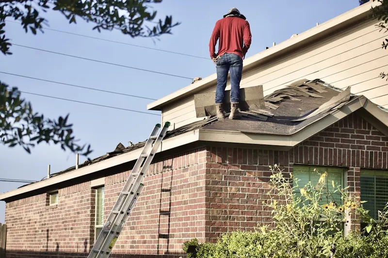 Professional roofer working on a residential roof in High Hill Farms